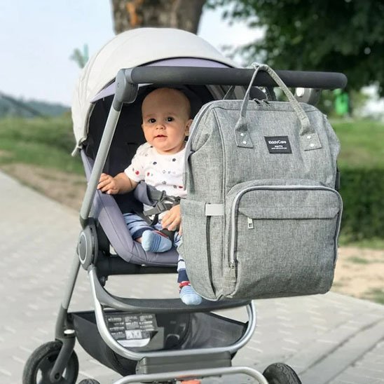 sac à langer multifonction attaché a la poussette bebe assis dans la poussette en chemin