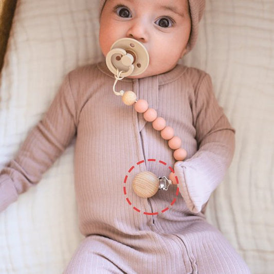 attache tetine en bois fiable fixée sur vêtement bébé