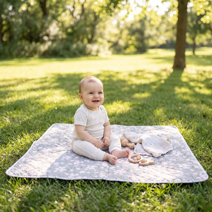 bébé assis sur tapis pour table a langer lavable au parc