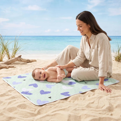 bébé couche sur tapis à langer voyage hearts sur plage avec maman