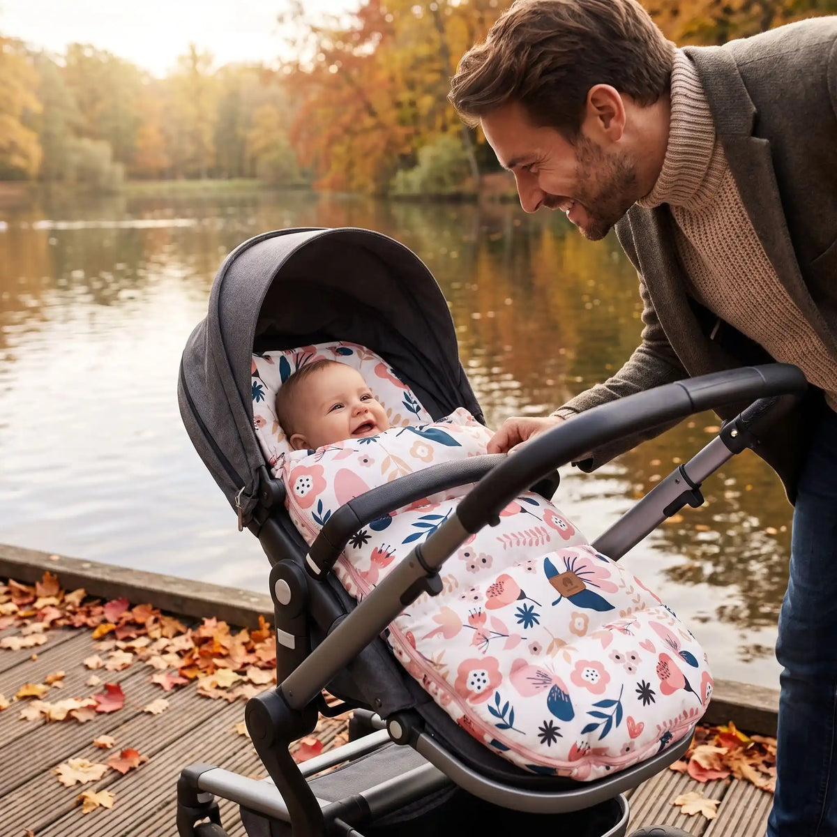 bébé dans chanceliere chaude babyunivers au bord d'eau avec papa