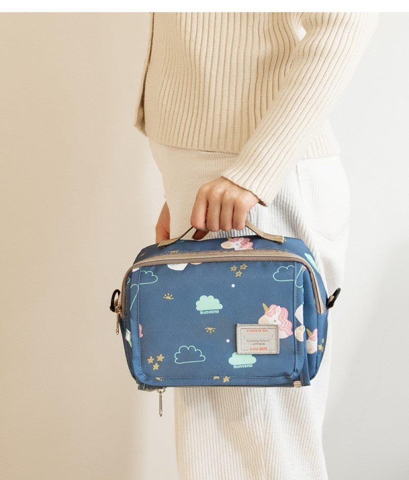 maman porte sac a langer bebe imperméable par la main