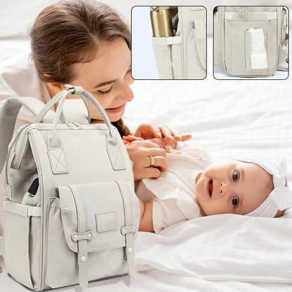 maman joue avec bébé couché sur le lit sac à langer momélégance sur le lit