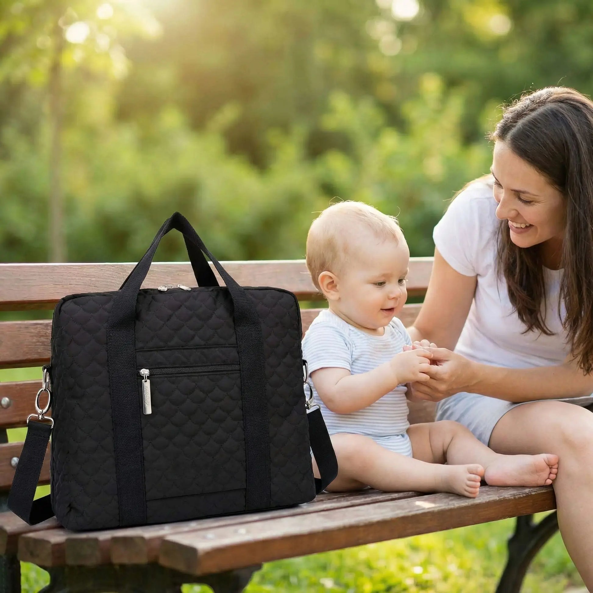 sac a langer elegance sur un banc à coté de maman et bébé
