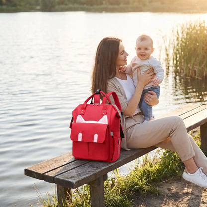 sac a langer urban chic parent sur banc avec maman et bébé